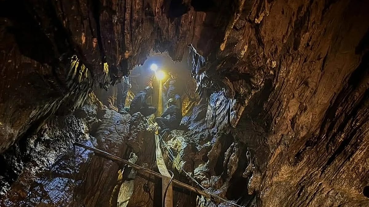 Rescue team members working together at cave entrance in Xaisomboun province, Laos