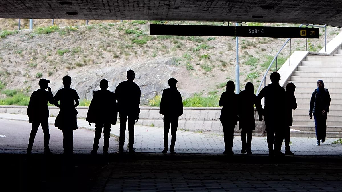 Young migrants walking together in Swedish neighborhood showing community integration and hope for future
