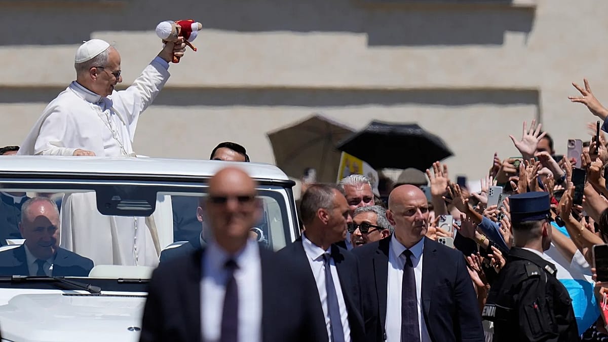Pope Leo XIV waving to crowds during his multi-city tour of Spain