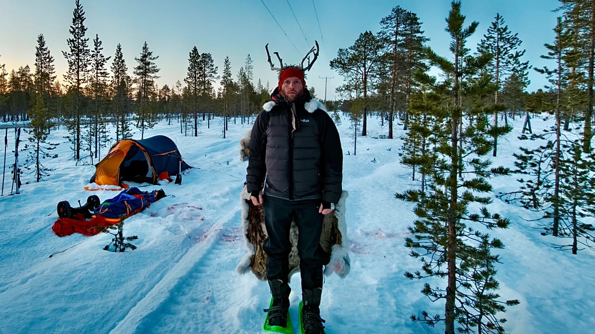 Tom Bailey pulling a sled across snowy Arctic landscape during his 600-kilometer climate theatre journey