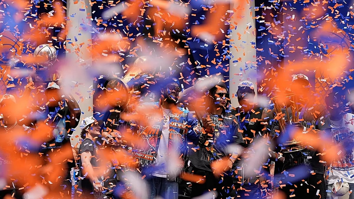 Thousands of New York Knicks fans in blue and orange celebrate during championship parade in Manhattan