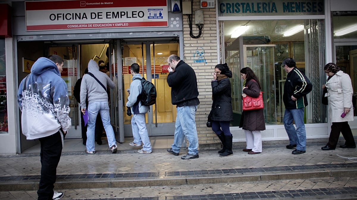 Spanish workers celebrating in busy city street with modern office buildings in background