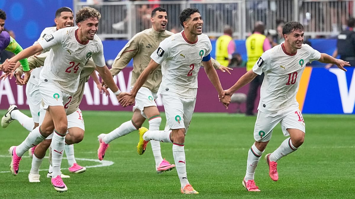 Moroccan player Azzedine Ounahi celebrating with teammates after World Cup victory over Canada