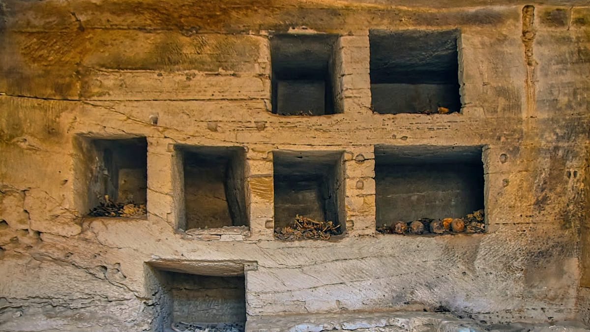 Ancient Egyptian tomb entrance carved into rock at Marina El Alamein archaeological site