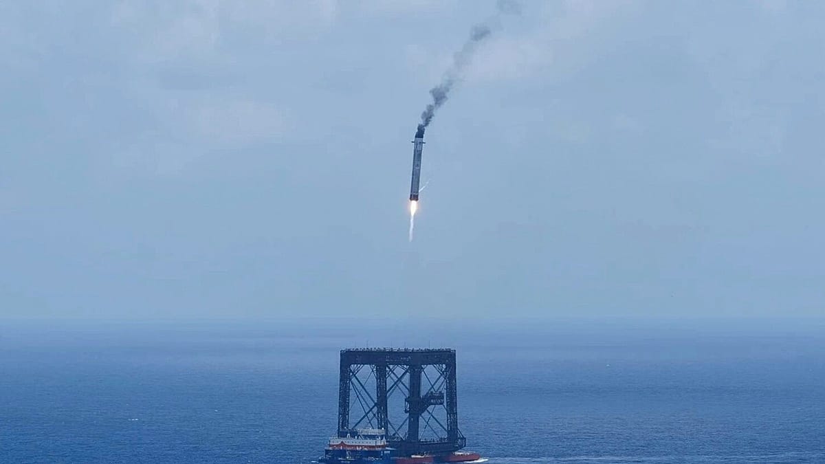 Long March-10B rocket booster descending toward floating ocean platform during historic controlled landing