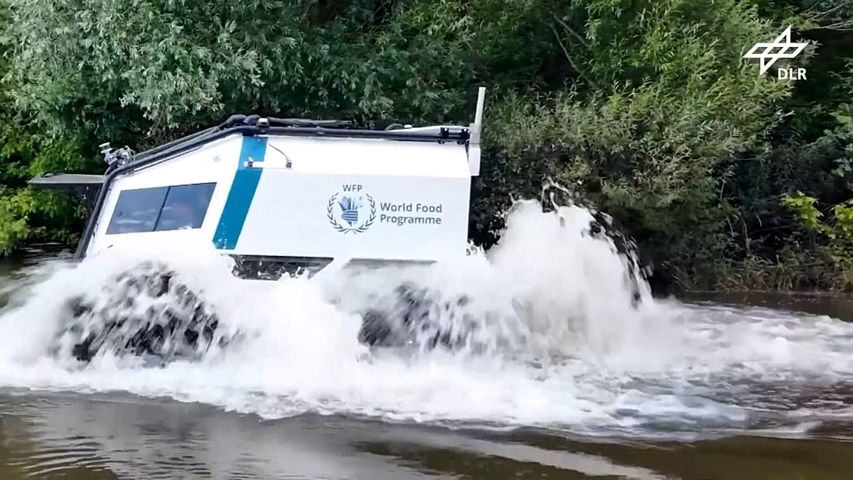 Unmanned all-terrain vehicle crossing water during humanitarian aid delivery test in Germany