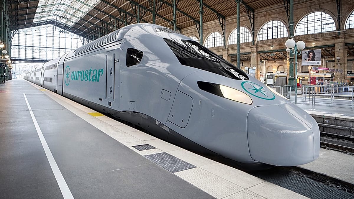 Modern high-speed Eurostar train traveling through European countryside on sunny day