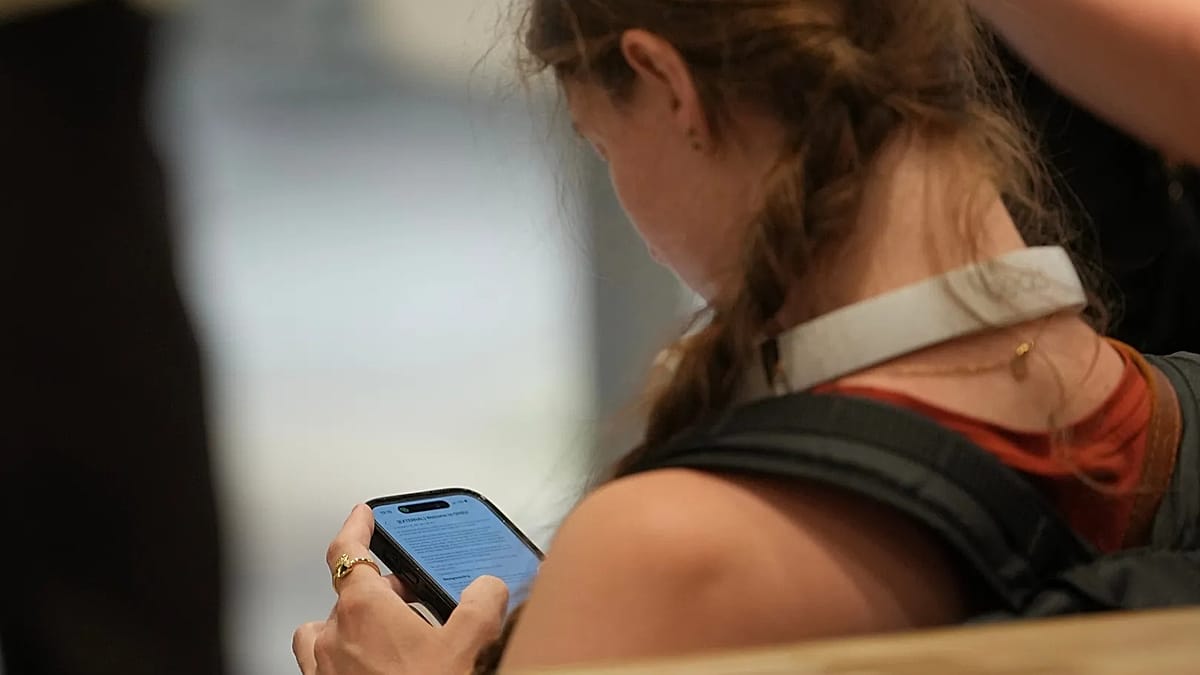 Teenager holding smartphone at night with social media apps displayed on screen