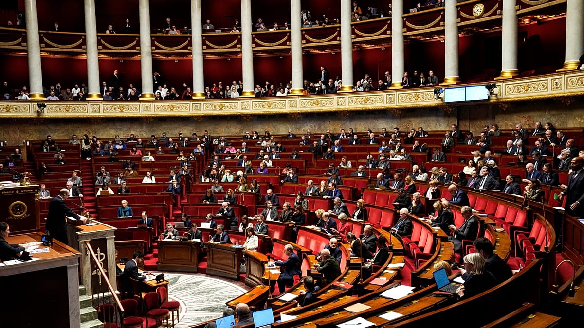 French National Assembly chamber with lawmakers voting on historic end-of-life legislation