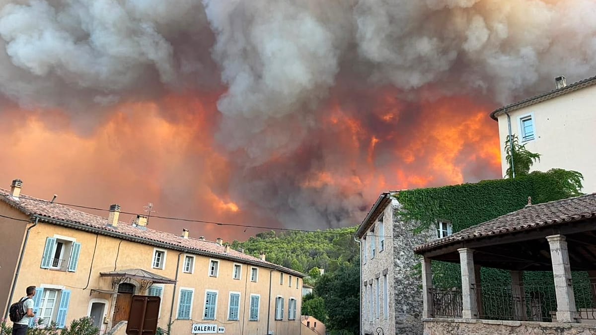 Smoke rising over the historic village of Cotignac in Provence, France during wildfire