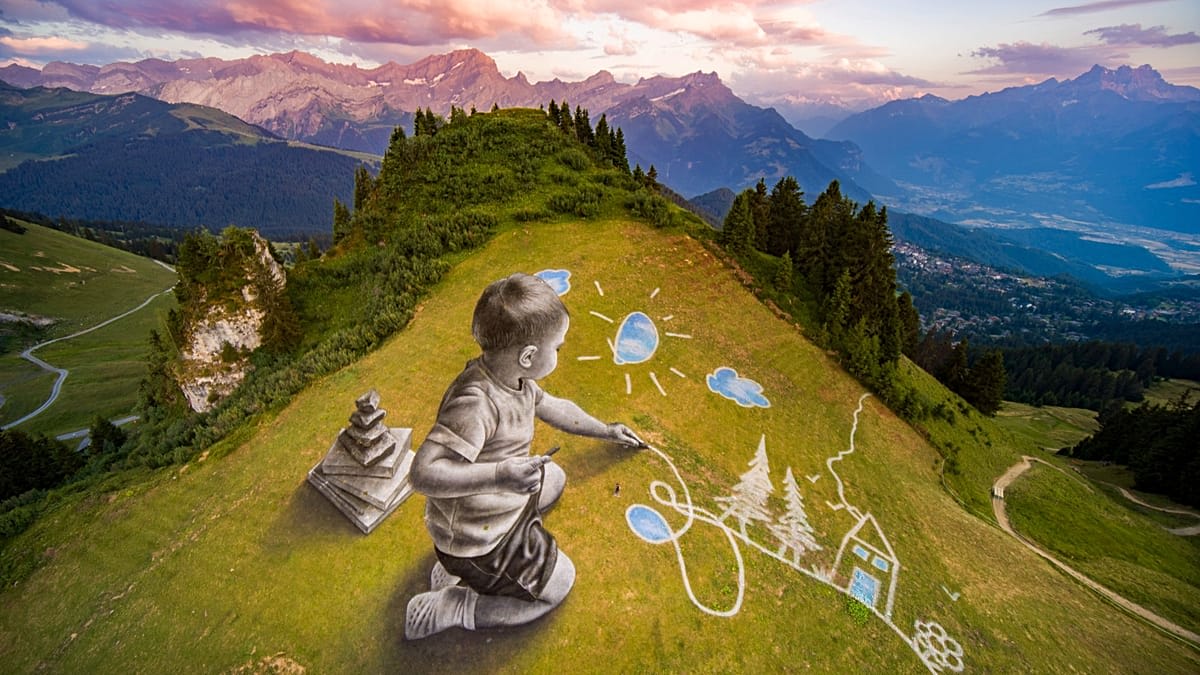 Massive temporary fresco painted on green alpine hillside showing child reaching toward sky