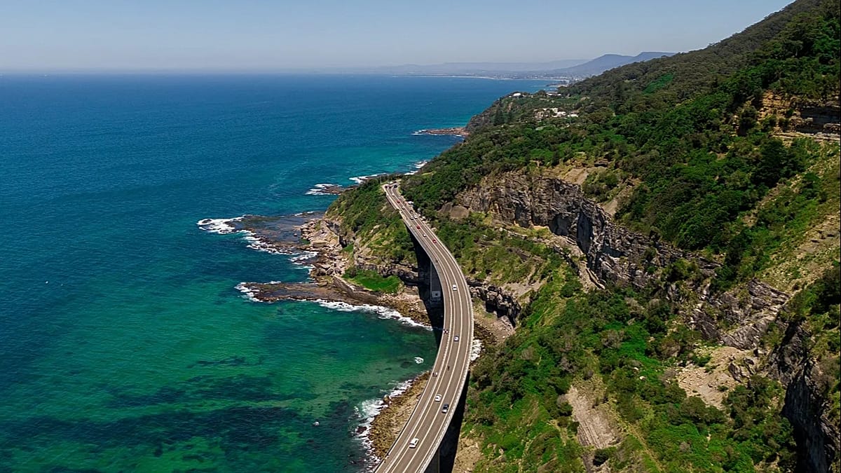 Winding coastal road along dramatic cliffs overlooking blue Mediterranean waters on European island