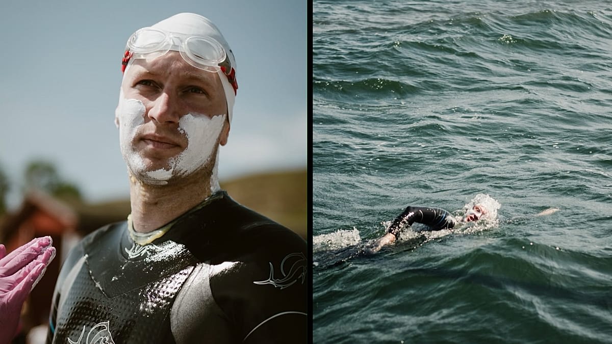 Long-distance swimmer Bartłomiej Kubkowski emerging from Baltic Sea waters onto Polish beach