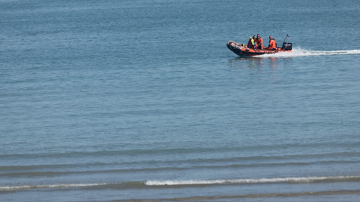 Rescue vessels and helicopter conducting coordinated maritime operation in English Channel waters
