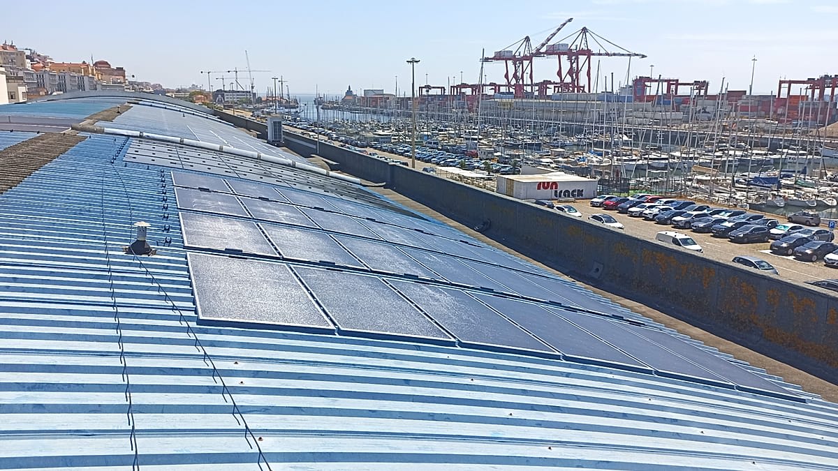 Solar panel array gleaming under bright Portuguese sunshine in summer landscape