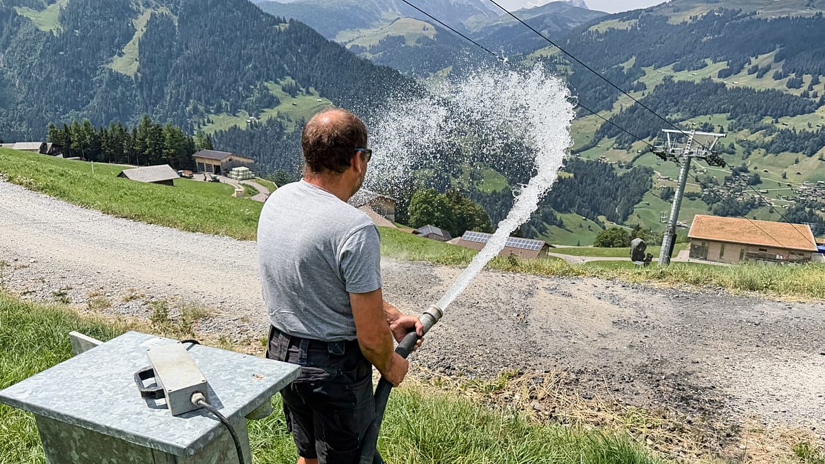 Snow cannon equipment stored at Swiss ski resort during summer months in mountain valley
