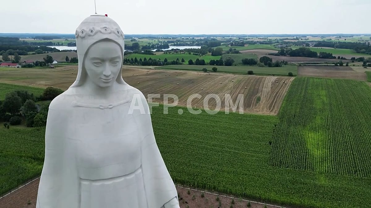 Towering concrete Virgin Mary statue rises 55 meters above Polish village landscape