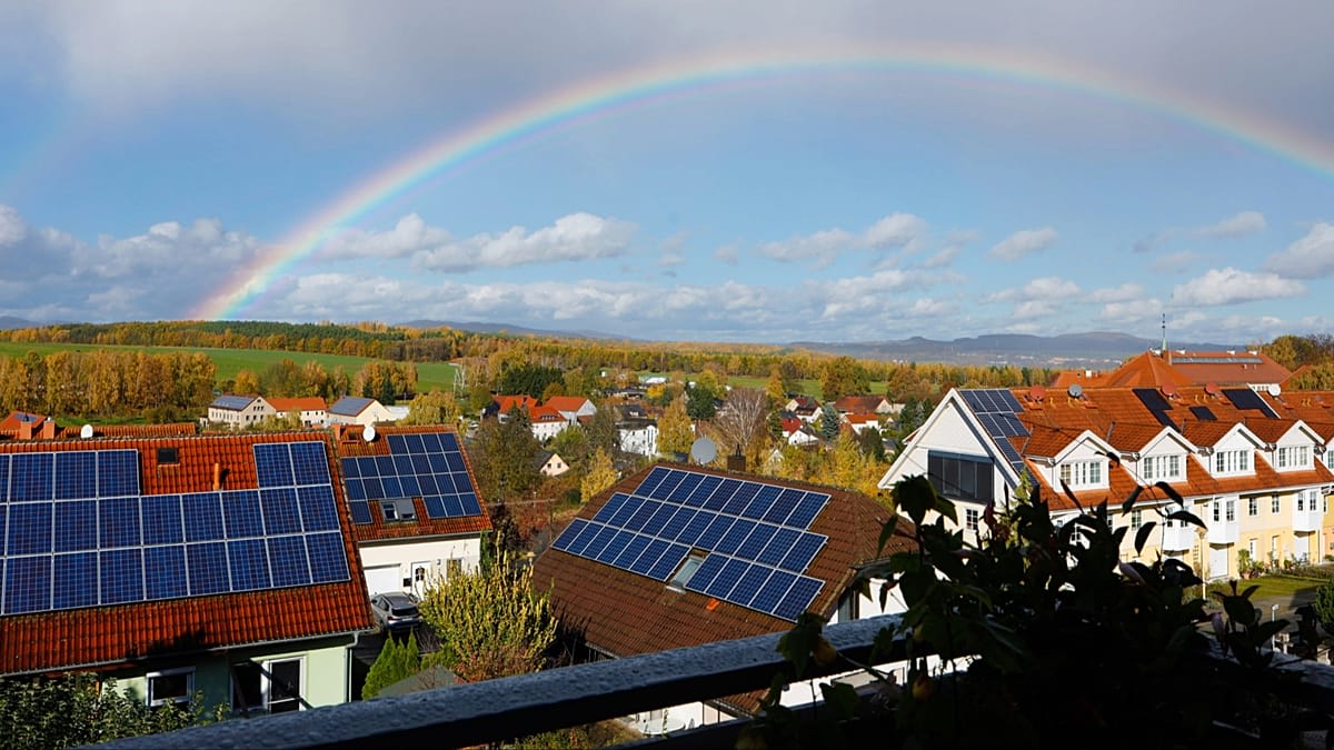 Modern heat pump and solar panels installed on residential German home rooftop