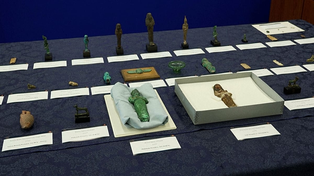 Ancient Egyptian artifacts including carved figurines and ceremonial amulets displayed together after FBI repatriation
