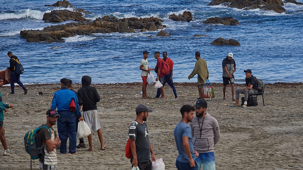 Dozens of recreational boats sailing across blue waters toward Ceuta harbor in solidarity flotilla