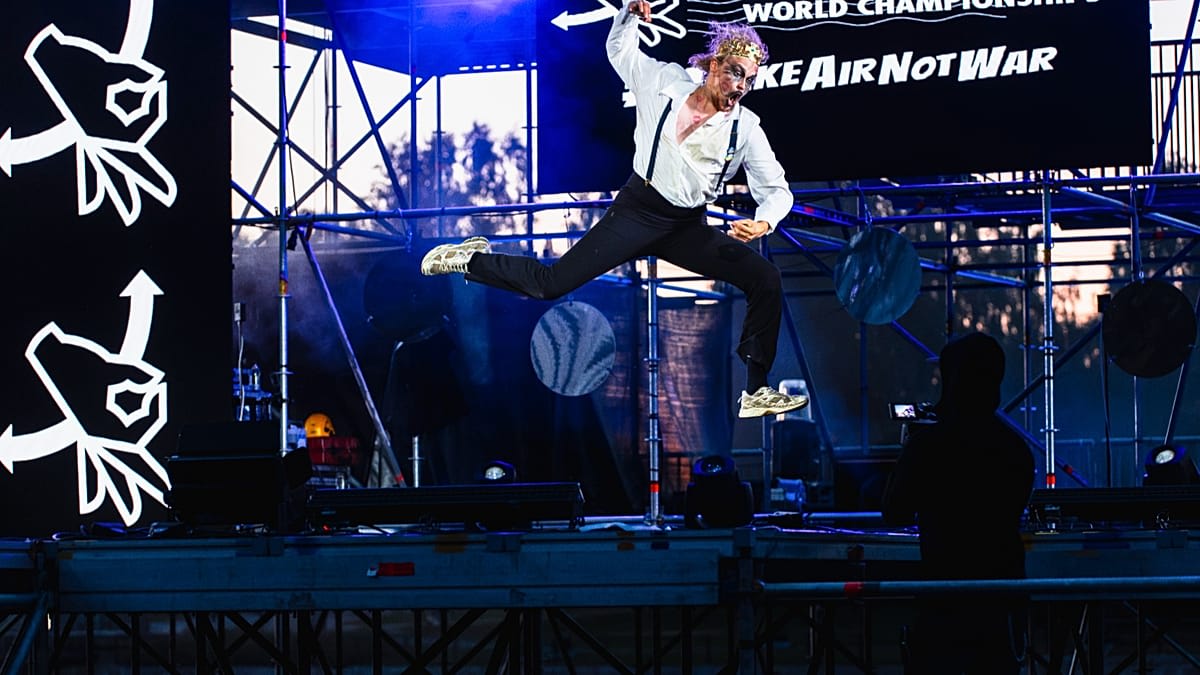 Finnish air guitar champion Aapo Rautio performing energetic rock moves on invisible guitar
