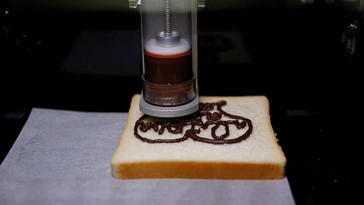 3D food printer creating colorful heart-shaped chewable medication tablet for young patients