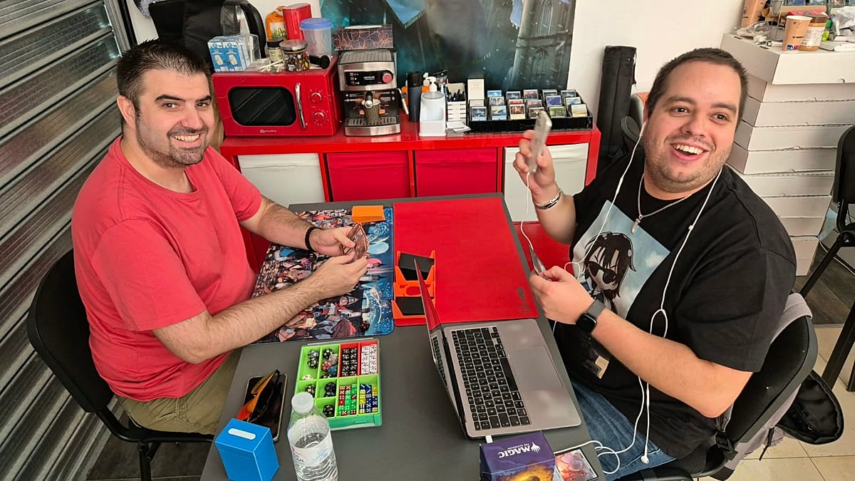Blind gamer Cristian Amores using smartphone with Magic: The Gathering cards at tournament table