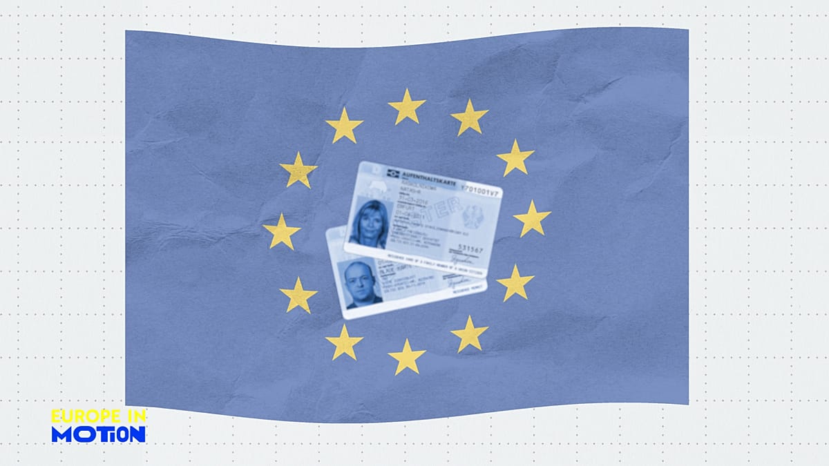 Diverse group of people holding residence permit documents and smiling in European city setting