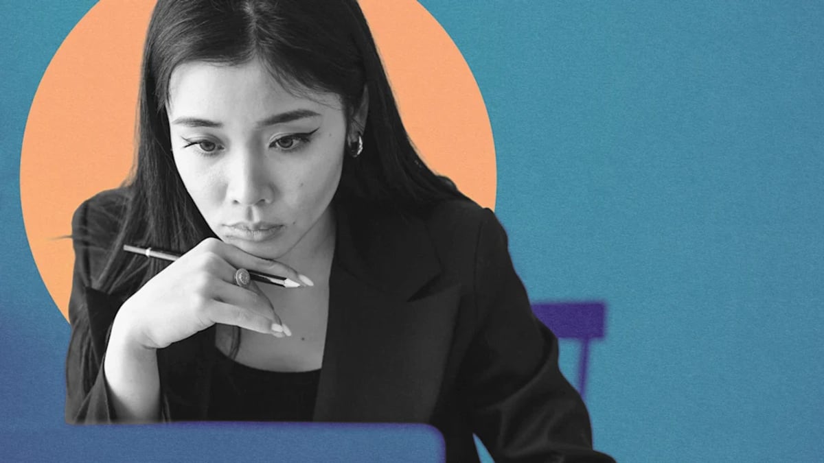 Professional woman working on laptop while caring for family members at home