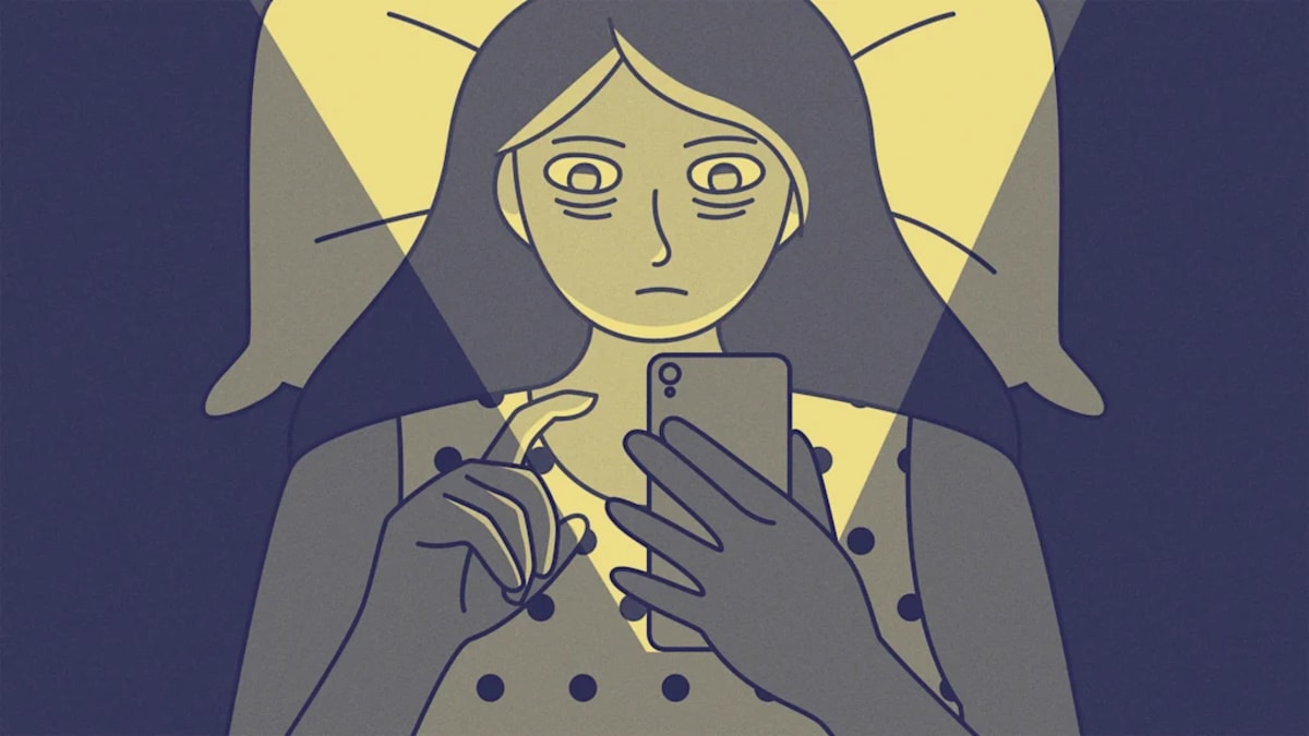 Person placing smartphone face down on table away from workspace for better focus