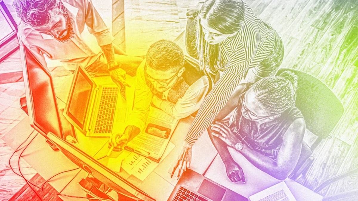 Professional woman using laptop with AI productivity tools displayed on screen in modern office