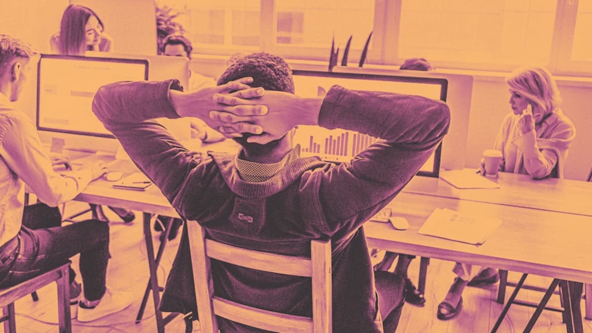 Professional taking a mindful pause at desk, breathing slowly with calm expression during busy workday