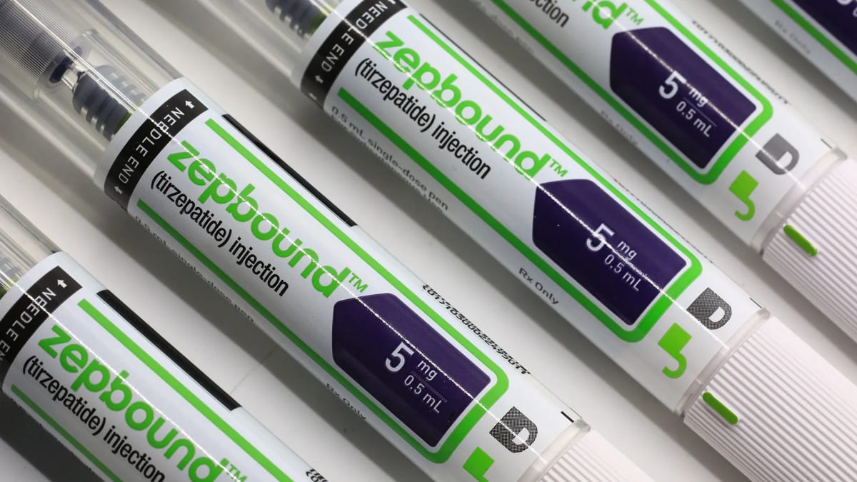 Healthcare professional discussing prescription medication benefits with employee in modern office setting