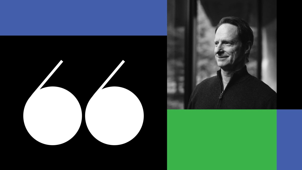 Business executive reviewing financial documents at desk with laptop and coffee