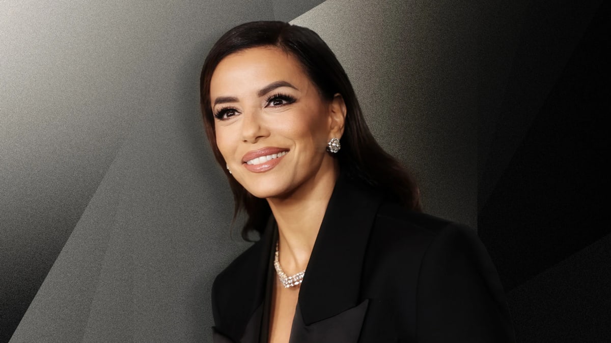 Eva Longoria smiling at camera, embodying confidence and success at age 51
