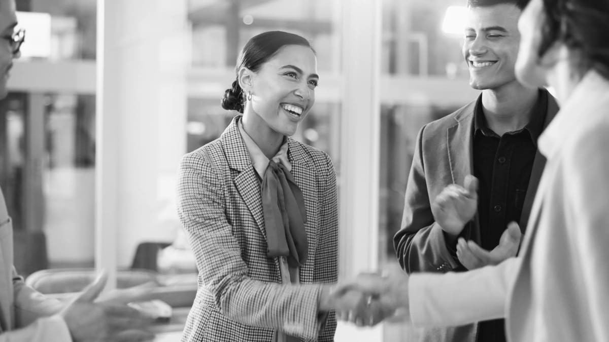 Two professionals having genuine conversation over coffee, showing authentic workplace friendship and connection