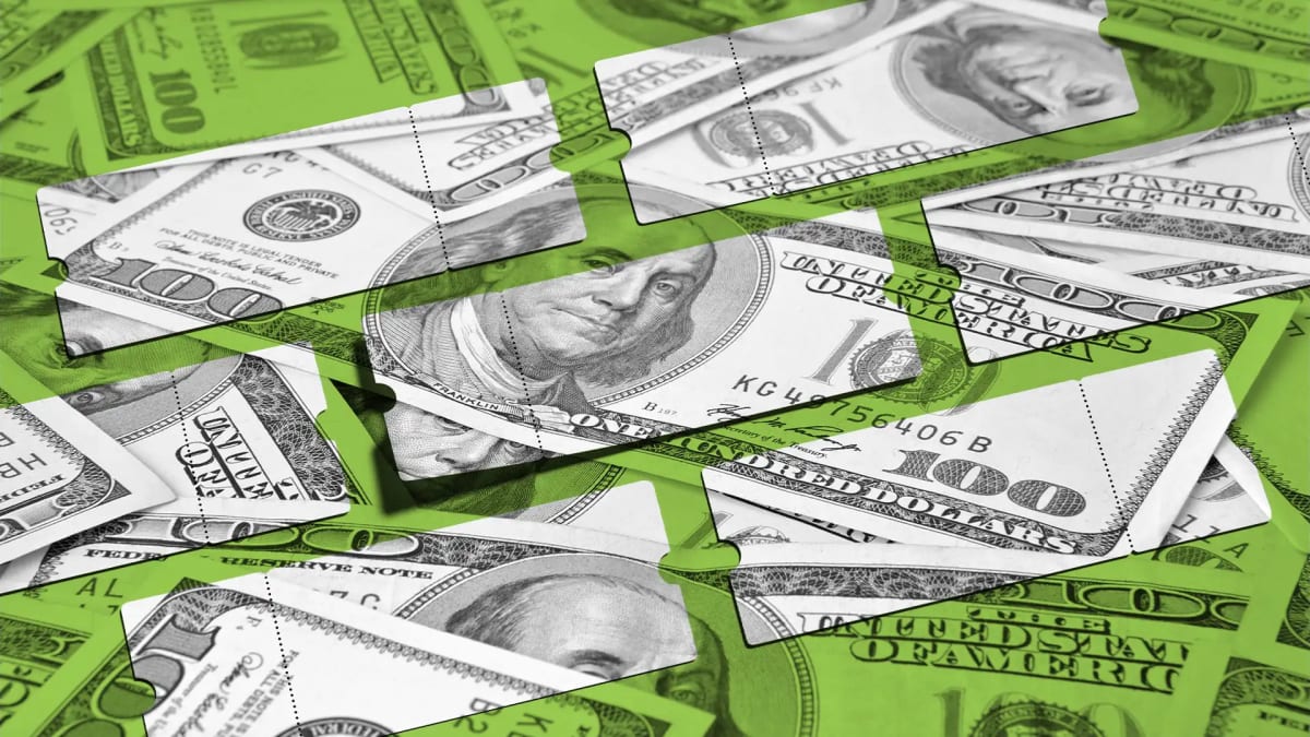 Person holding smartphone showing Ticketmaster app with ticket purchase screen and pricing details