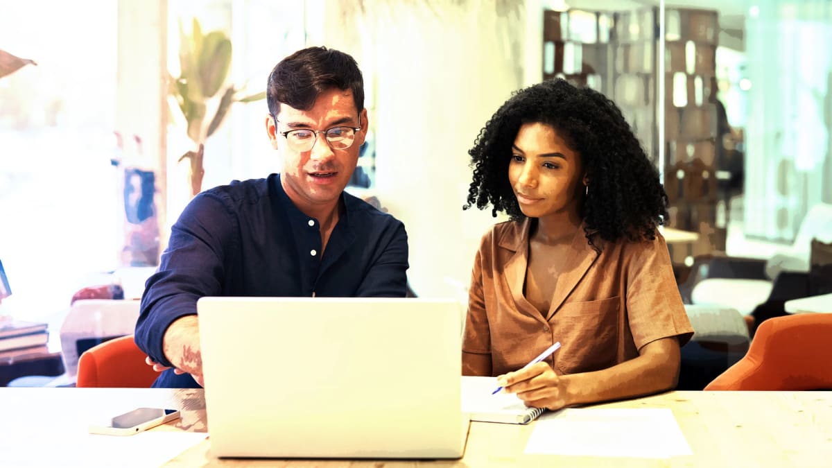 Diverse group of professionals collaborating happily in modern office setting