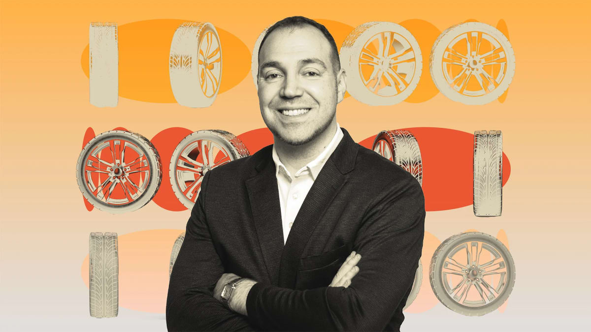 Entrepreneur Jared Kugel standing confidently in Tire Agent warehouse with inventory behind him