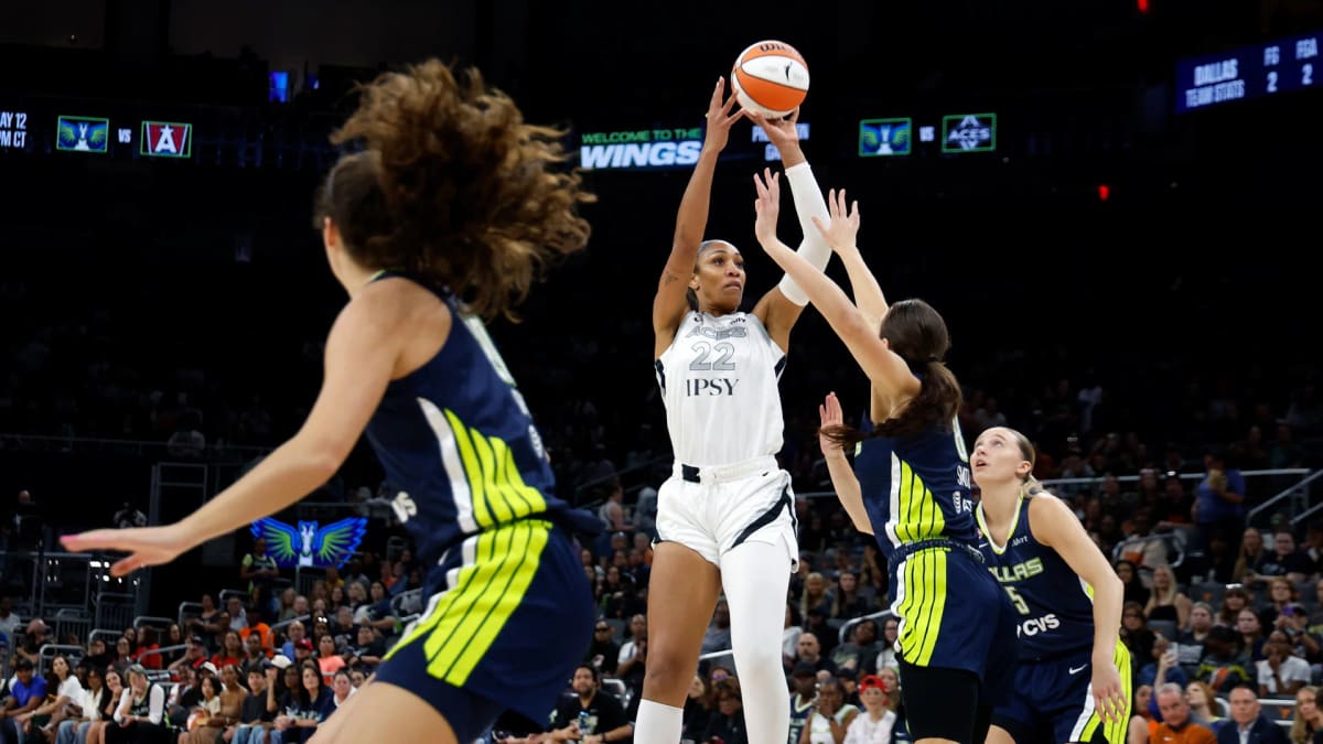 WNBA basketball players celebrating on court during opening night of season thirty