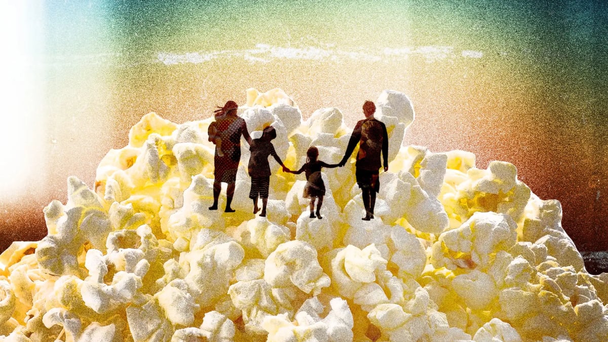 Families enjoying popcorn and movies together in a bright, welcoming theater auditorium