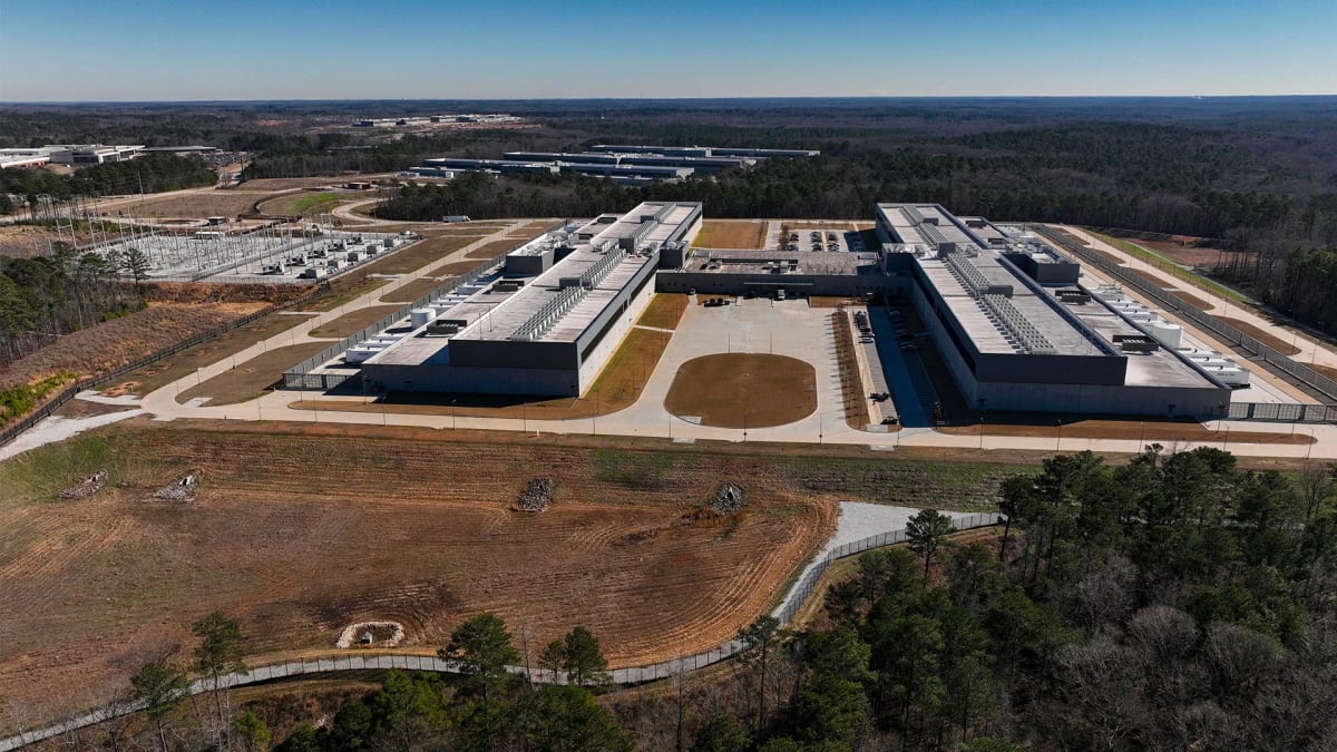 Modern data center facility with rows of servers connected to electrical power grid infrastructure