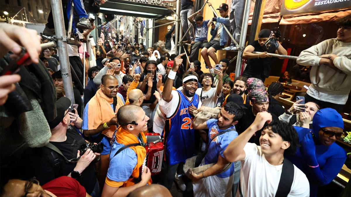 New York Knicks fans celebrating together in orange and blue team colors