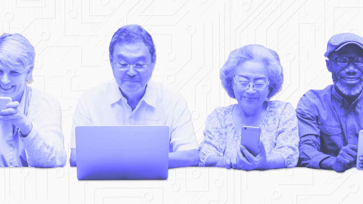 Smiling senior adult using laptop computer while engaging with artificial intelligence chatbot technology