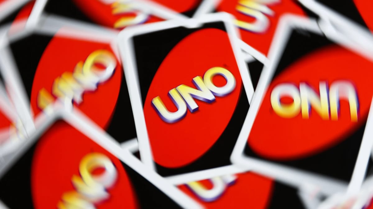 Players holding colorful UNO cards during an intense tournament game competition