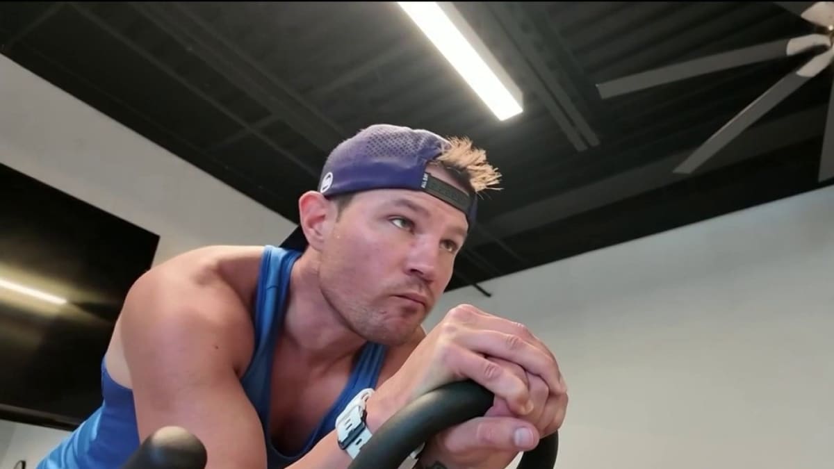 Aaron Wright crossing Ironman triathlon finish line after recovering from advanced colon cancer treatment