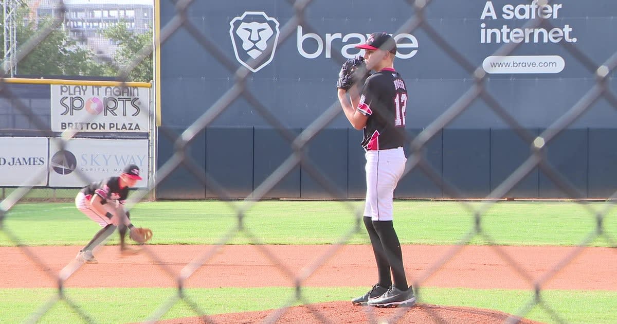 Thirteen-year-old baseball pitcher Brody House standing on the mound in his uniform after cancer recovery