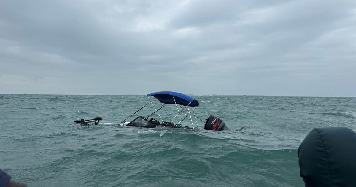 Charter fishing boat on Lake St. Clair during rescue operation of sinking vessel