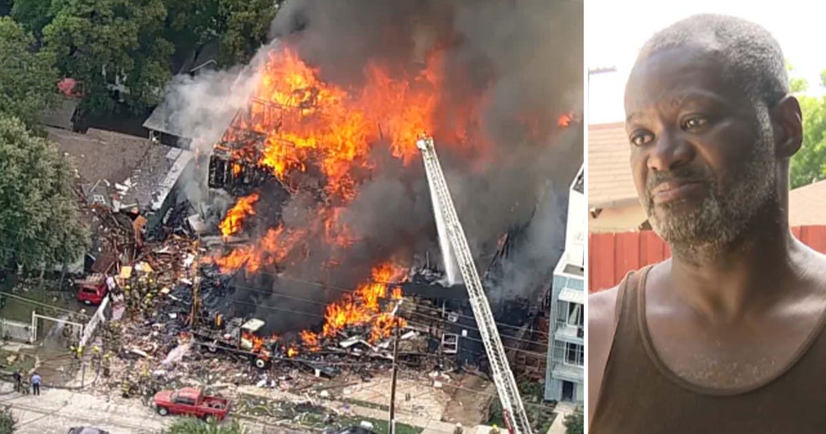Dallas apartment building engulfed in flames with black smoke rising into sky