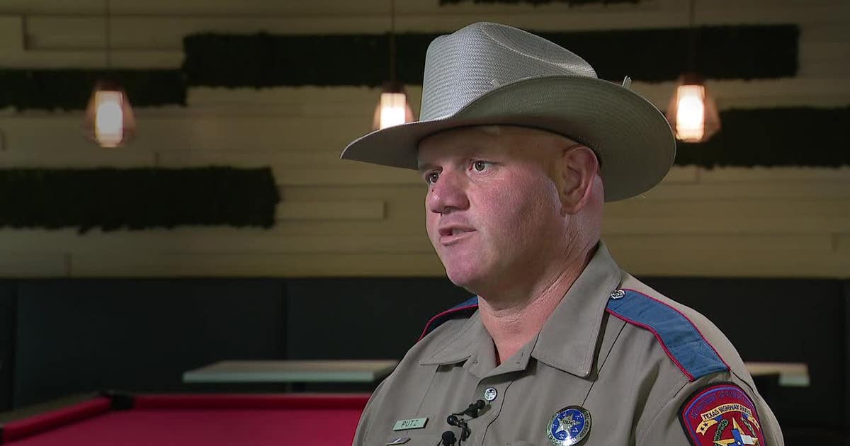Texas DPS Trooper Curtis Putz in tan uniform speaking at trauma survivors reunion event